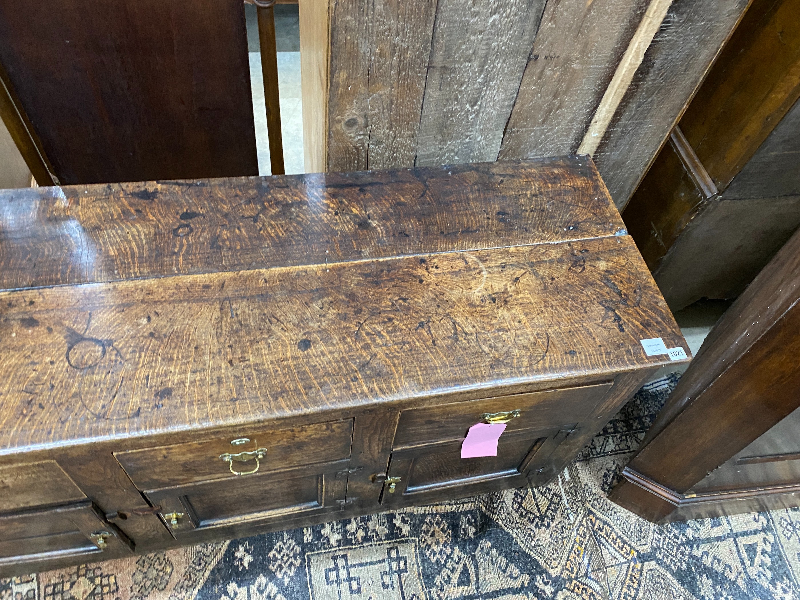 A late 18th century oak low dresser, the frieze with a small later added drawer, length 157cm, depth 52cm, height 75cm